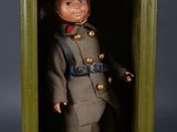 toy soldier in a doghouse on a black background