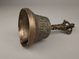 a metal bell that is sitting on a table