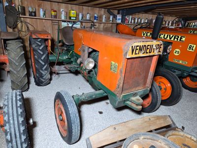 many old tractors in the garage of this house