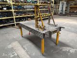 a metal work bench in a warehouse with lots of shelves