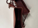 the inside of a brown leather purse with a rope around it