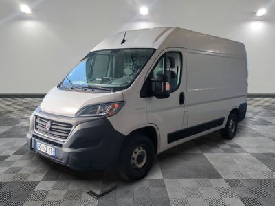 the white van is parked on a checkered floor in the garage