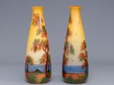 two vases with trees painted on them sitting side by side