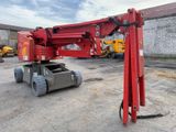 a red crane sitting on top of a truck in a parking lot