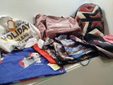 a pile of clothes and a backpack on a shelf