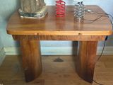 a wooden table with a lamp on top of it