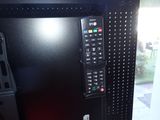 a television with a remote control attached to it