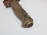 a small metal object on a white surface