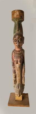 a wooden statue of a man with a hat on his head