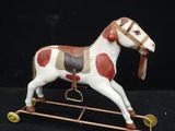 a toy horse that is sitting on top of a stand
