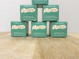 four boxes of soap sitting on top of a wooden table