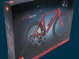 a red bike in a black box on a blue background