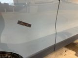 a car with a sticker on the side of it ' s door