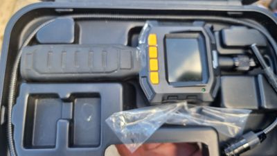 a person holding a camera in a plastic case