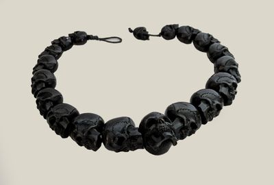 a close up of a bracelet with skulls on it