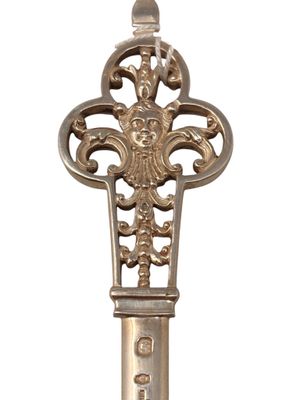 a silver spoon with a decorative design on it