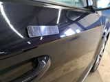 a close up of a car door handle with a sticker on it