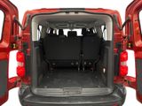 the back of a red van with its doors open showing the cargo area