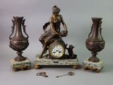 a statue of a woman sitting on top of a table next to three vases