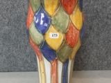 a colorful vase that is sitting on a table