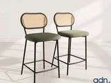 pair of black metal barstools with green upholstered seats