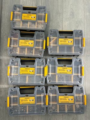 a group of six yellow and black tool boxes sitting on top of a wooden floor