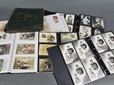 an image of a collection of old photographs and a book on a table