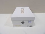 a white box with gold lettering on it on a table