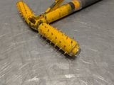 a yellow bat that is laying on a metal surface
