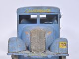 a blue toy truck that is sitting on a white surface