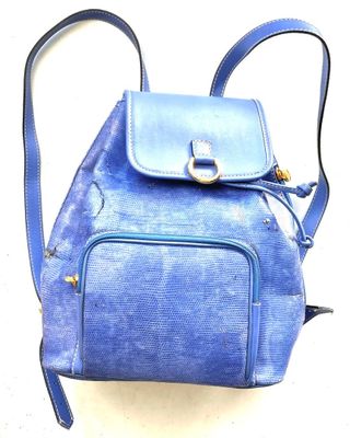 a blue backpack that is sitting on a white surface
