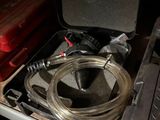 an image of a suitcase with a hose in it
