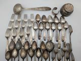 a lot of silver spoons and silverware on the table
