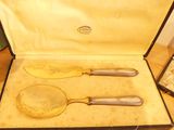 two spoons and a knife in a case