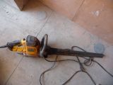 a chainsaw on the floor next to a piece of wood