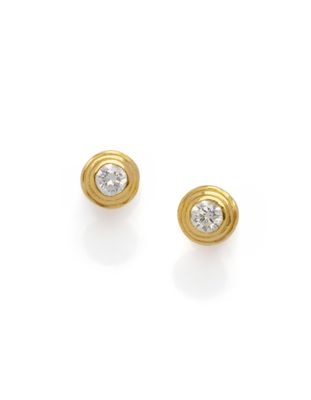 a pair of yellow gold and diamond earrings