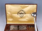 a wooden box with silverware in it on a table