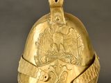 an image of a gold helmet on a stand with a black background