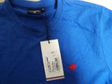 a close up of a blue t - shirt with a tag on it