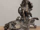 a statue of a woman riding a turtle on top of a table