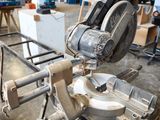 a machine that is cutting a piece of wood in a factory