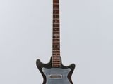 an electric guitar hanging from a string on a white background