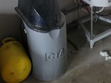 an image of a room with a tank and a trash can