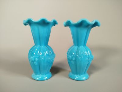 two blue vases sitting next to each other on a table