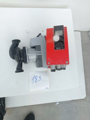 a red and black water pump on a white table