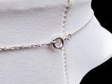 a close up of a white mannequin with a chain around it
