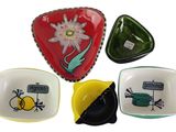 four plates with different designs on them on a white background