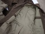 a jacket that is laying on the ground next to a bag