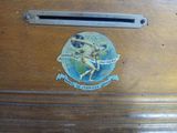 a wooden box with a sticker on it that has a picture of a naked man on it