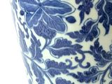 a blue and white vase with a floral design on it